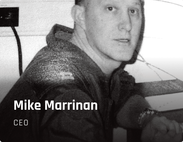Grayscale head-and-shoulders portrait of Mike Marrinan, CEO, looking slightly to the side in a professional setting.