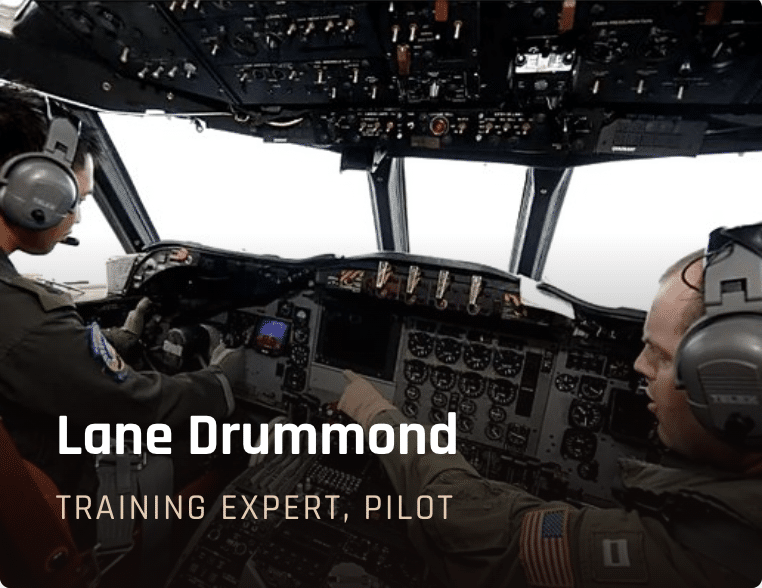 Two pilots in a cockpit during flight training, one pointing to controls as they fly the aircraft, Lane Drummond — Training Expert, Pilot